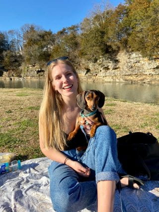 Chloe Kuebler headshot with dog